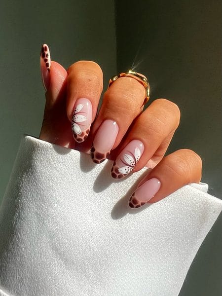 Caramel and mocha animal print French nails with white floral accents