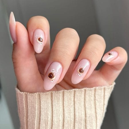 Milky pink almond nails with 3D tortoiseshell shell and floral accents
