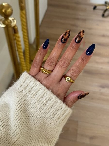 Midnight navy almond nails with honey amber tortoiseshell accents