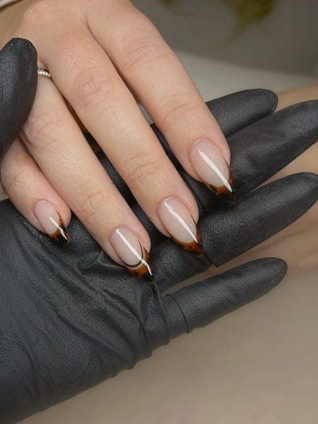 Almond nails with classic tortoiseshell V-cut French tips