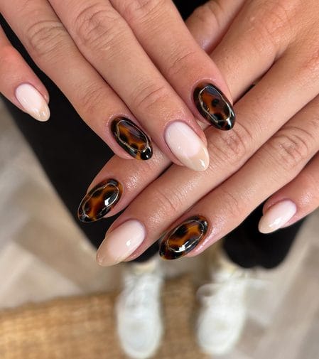 Milky nude nails with liquid gold framed tortoiseshell accents