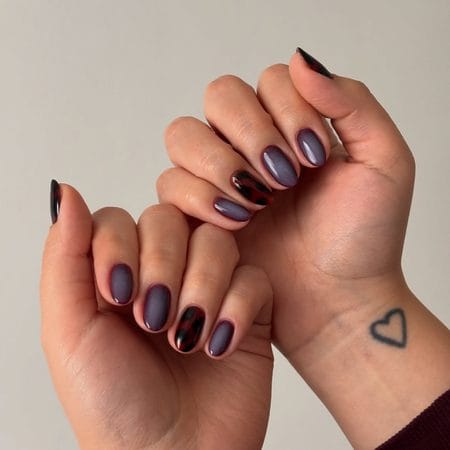 Smoked plum nails with deep crimson and black tortoiseshell accents