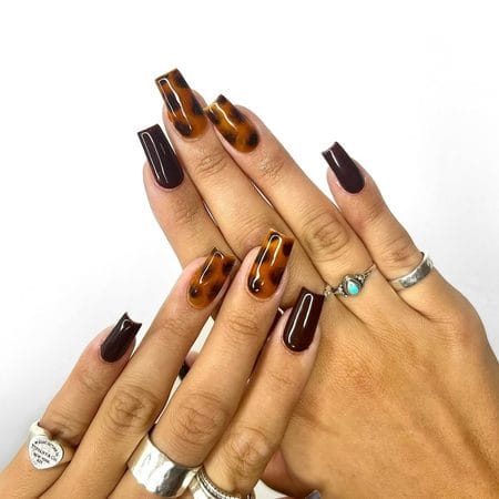 Long square nails with espresso polish and honey amber tortoiseshell details